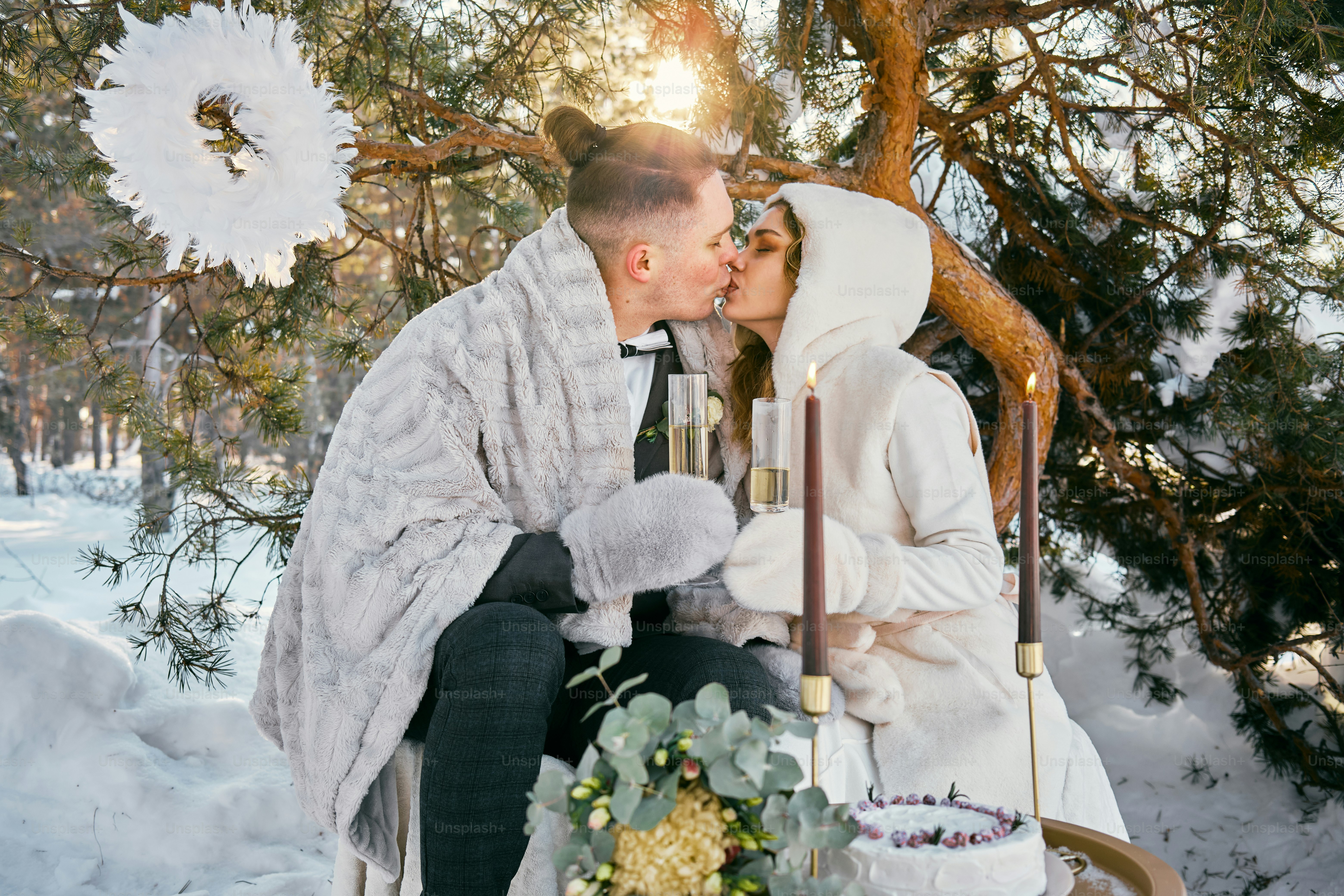un hombre y una mujer besándose en la nieve