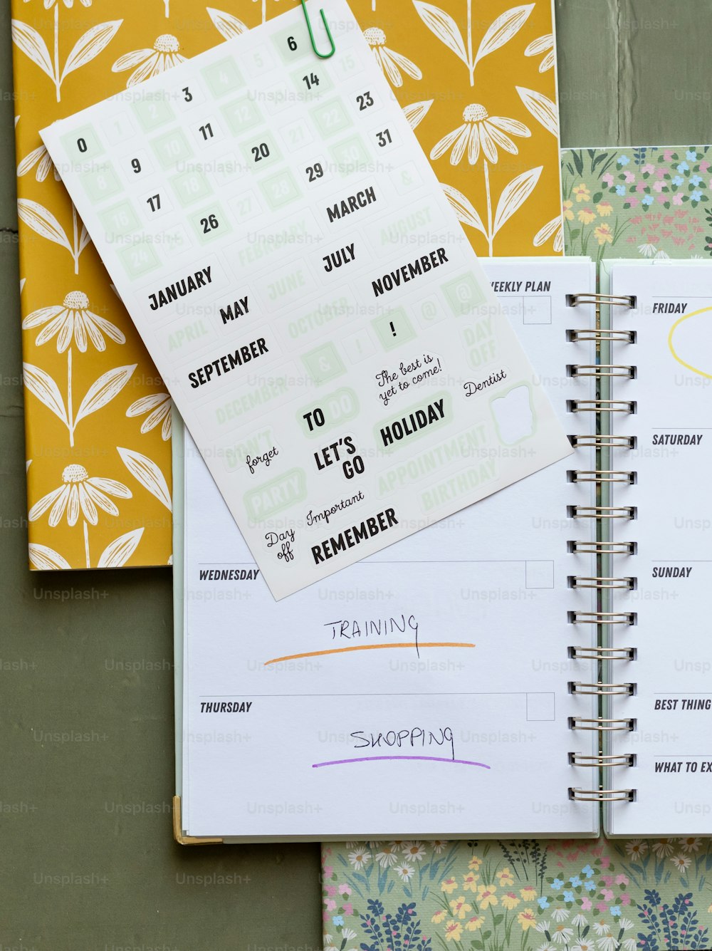 a planner and a calendar on a table