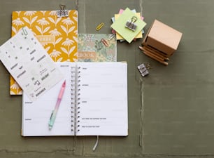 a notepad, pen, and other items on a table