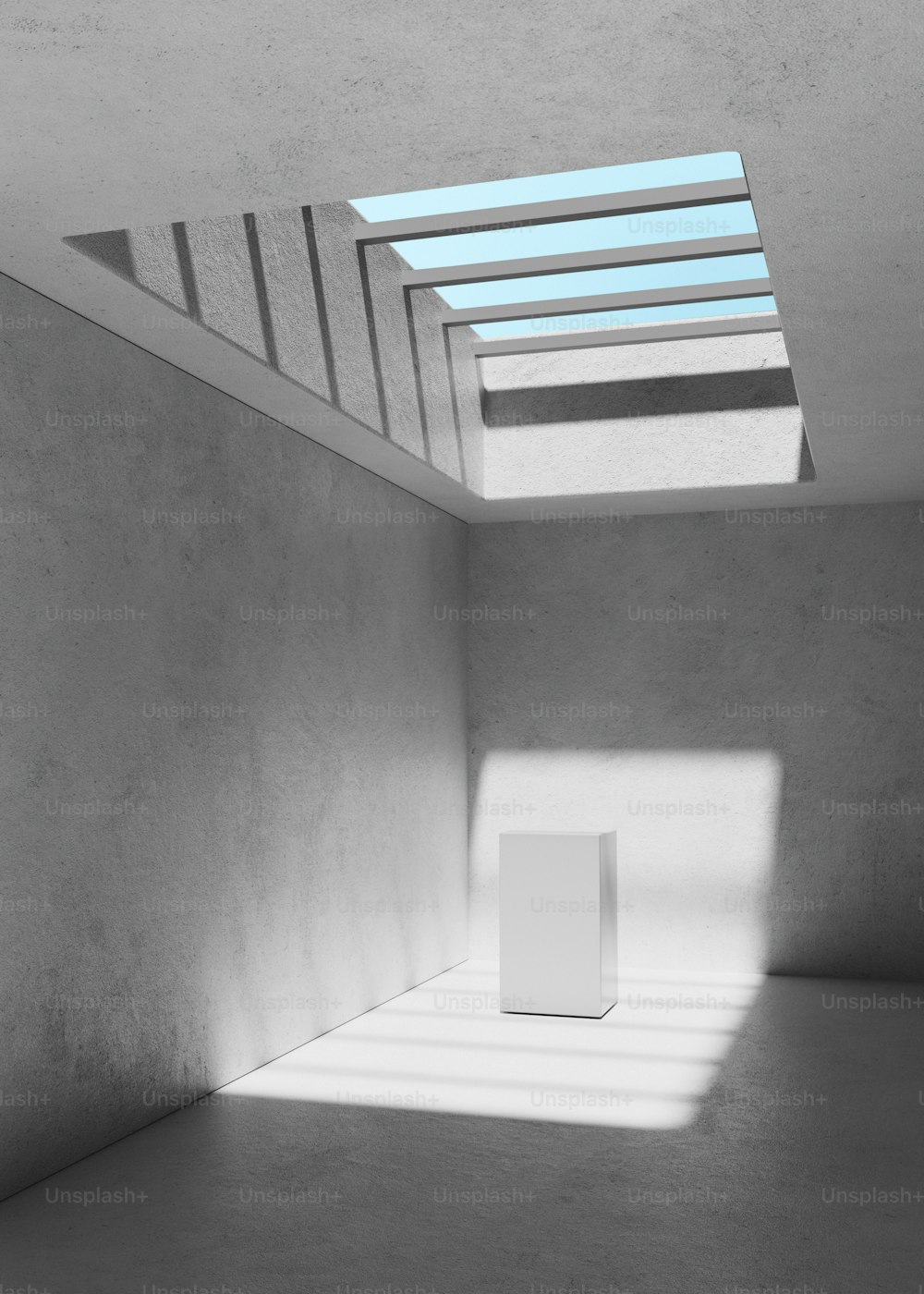 an empty room with a skylight and a white box
