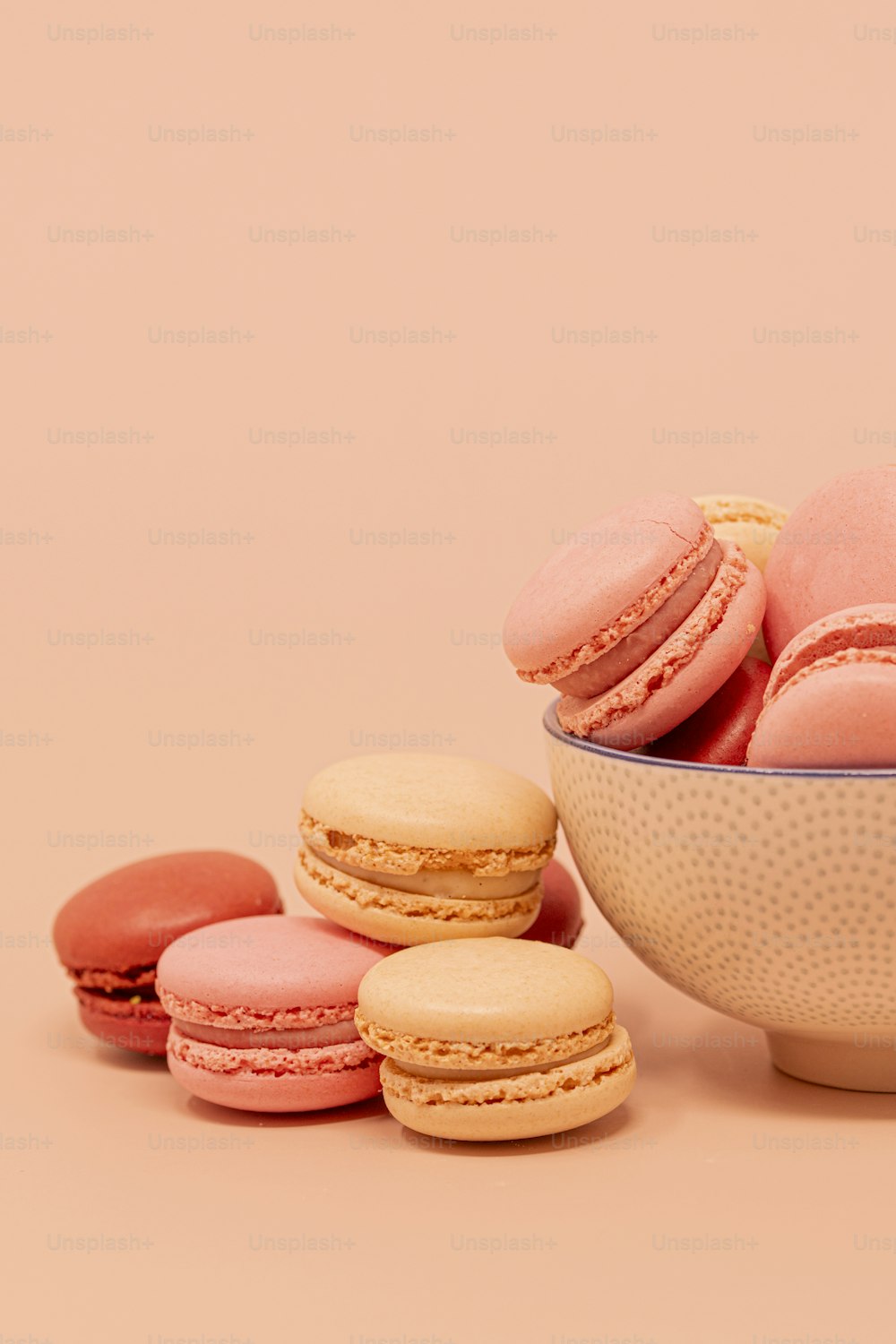 a bowl of macaroons next to a bowl of macaroons