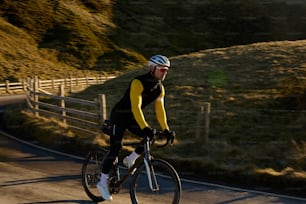 a man riding a bike down a curvy road