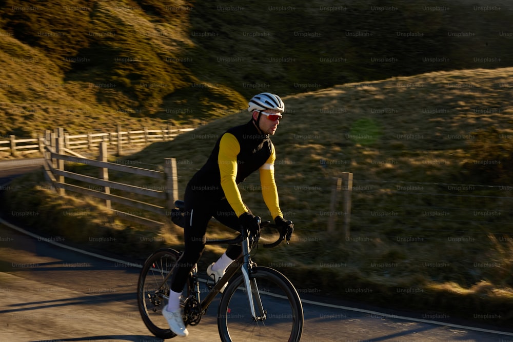 a man riding a bike down a curvy road