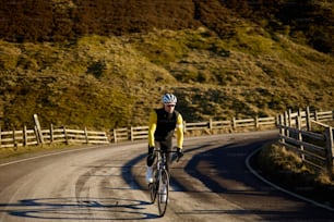 a man riding a bike down a curvy road