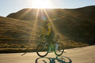 a man riding a bike down a road