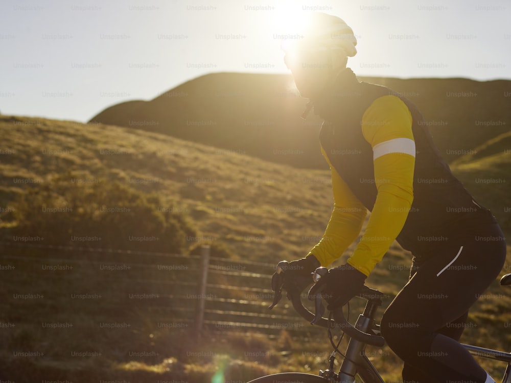 a man riding a bike down a dirt road