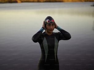 a woman in a wet suit is holding her head