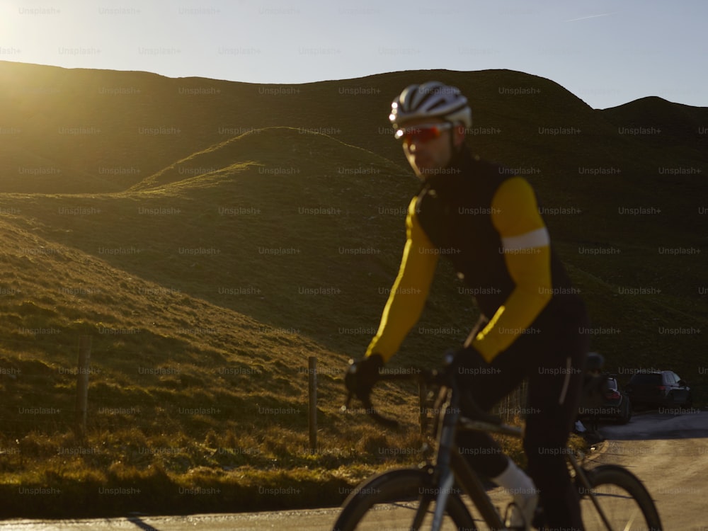 a man riding a bike down a road