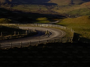 a person riding a bike down a curvy road