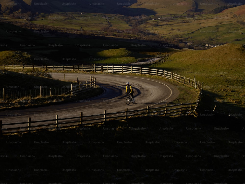 a person riding a bike down a curvy road