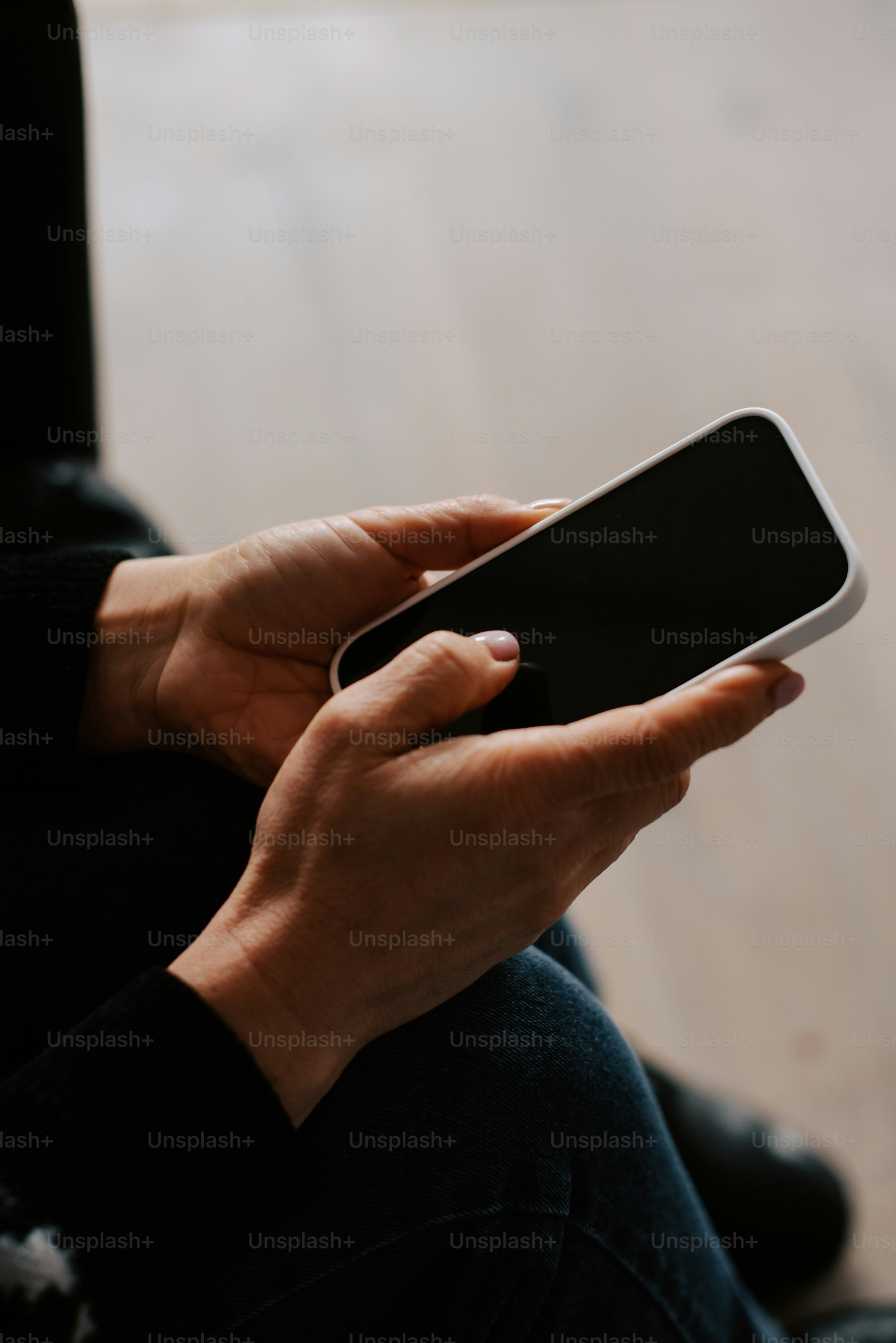 a person sitting on the floor holding a cell phone