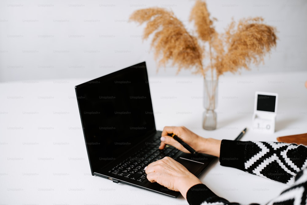 a person typing on a laptop on a table