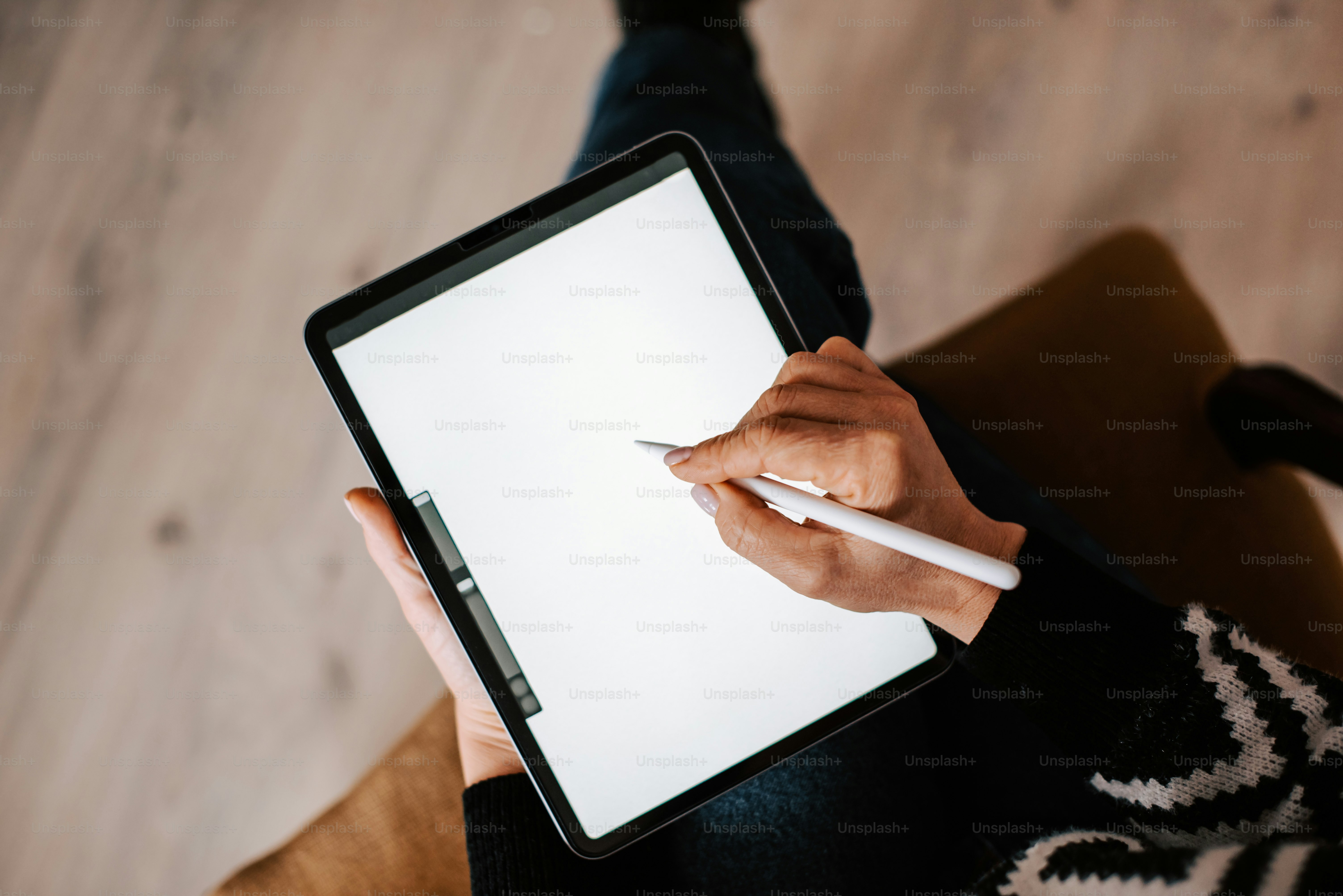 a person writing on a tablet with a pen