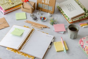 a table topped with lots of different types of notebooks