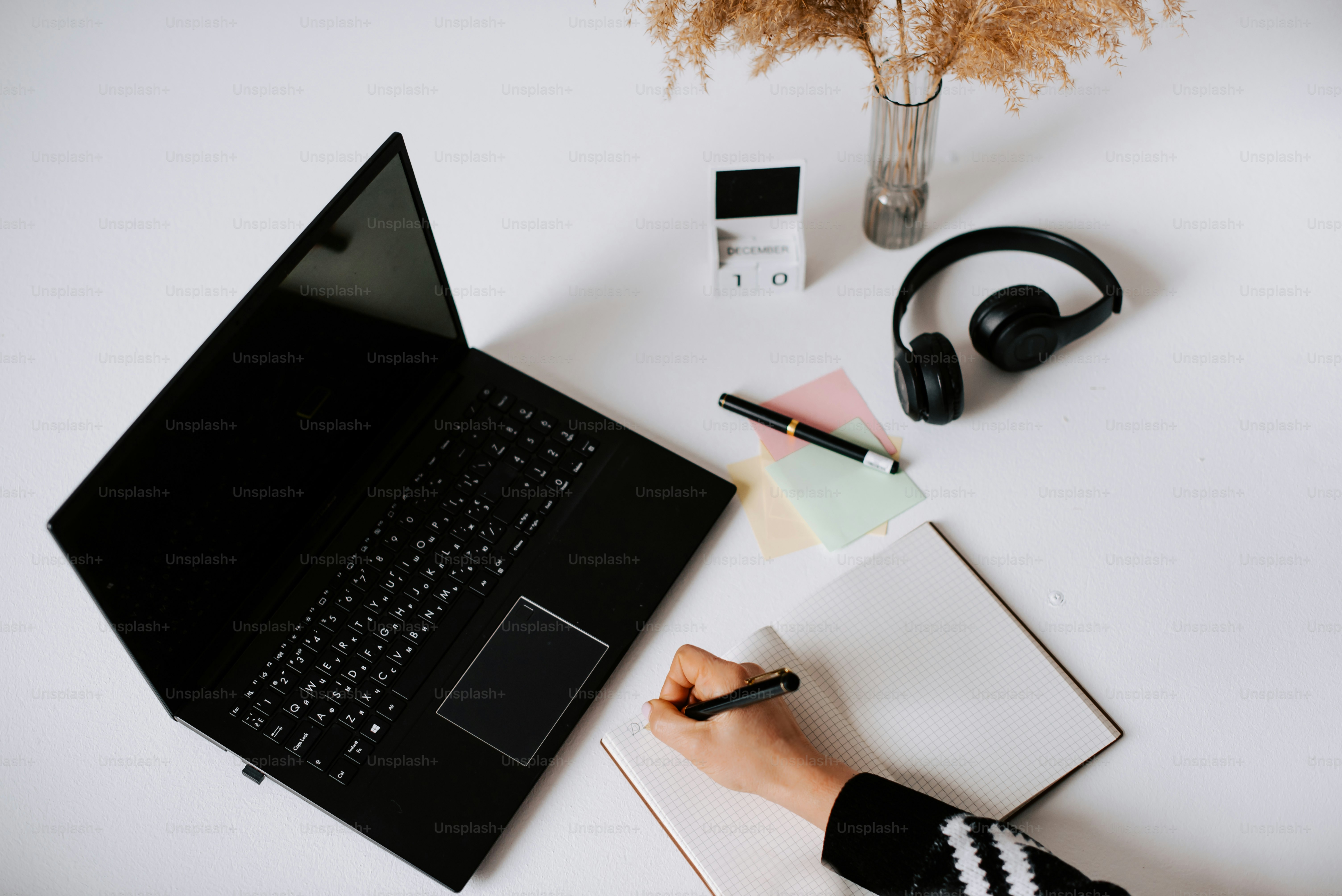a laptop computer sitting on top of a white desk