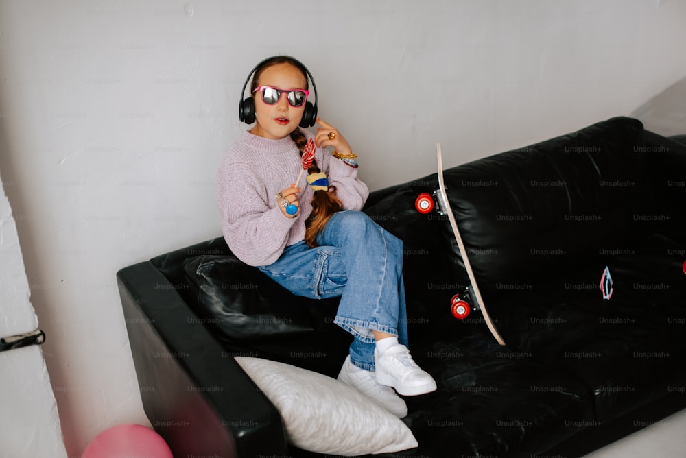 a woman sitting on a couch with headphones on