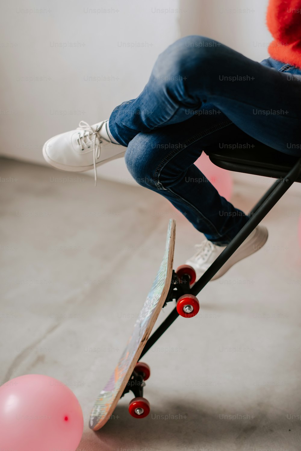 a person sitting on a chair with a skateboard