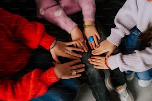 a group of people with their hands together