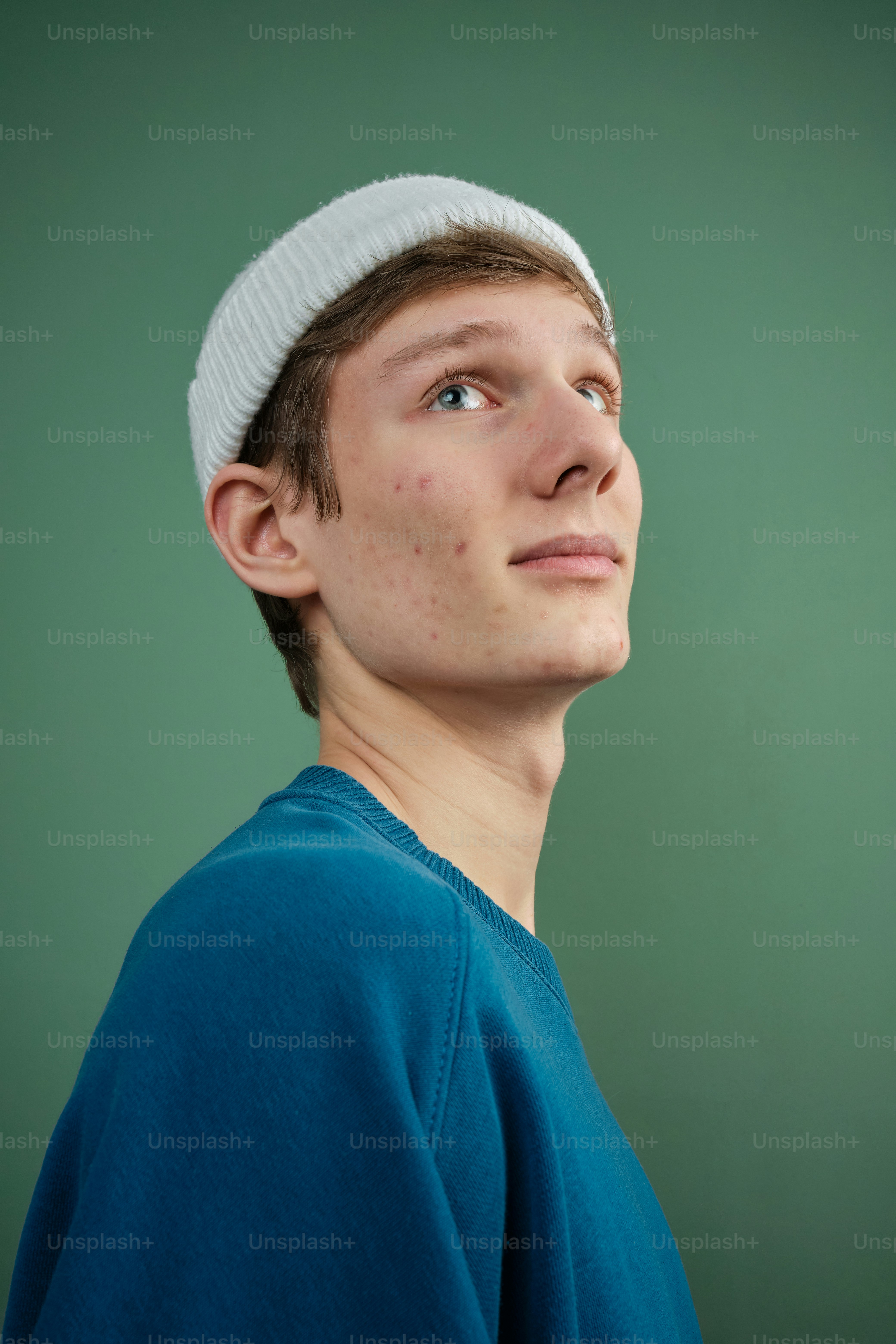 a man in a blue shirt and a white hat