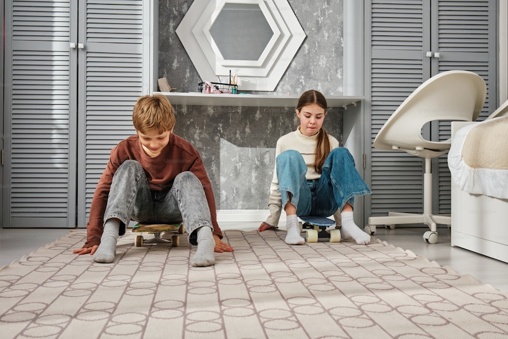 a couple of kids sitting on top of a rug