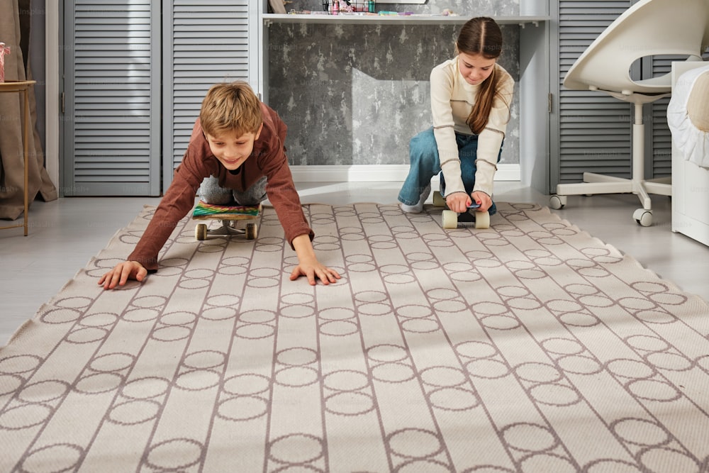 a young boy and girl playing on a rug