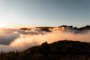 the sun is shining through the clouds over the mountains