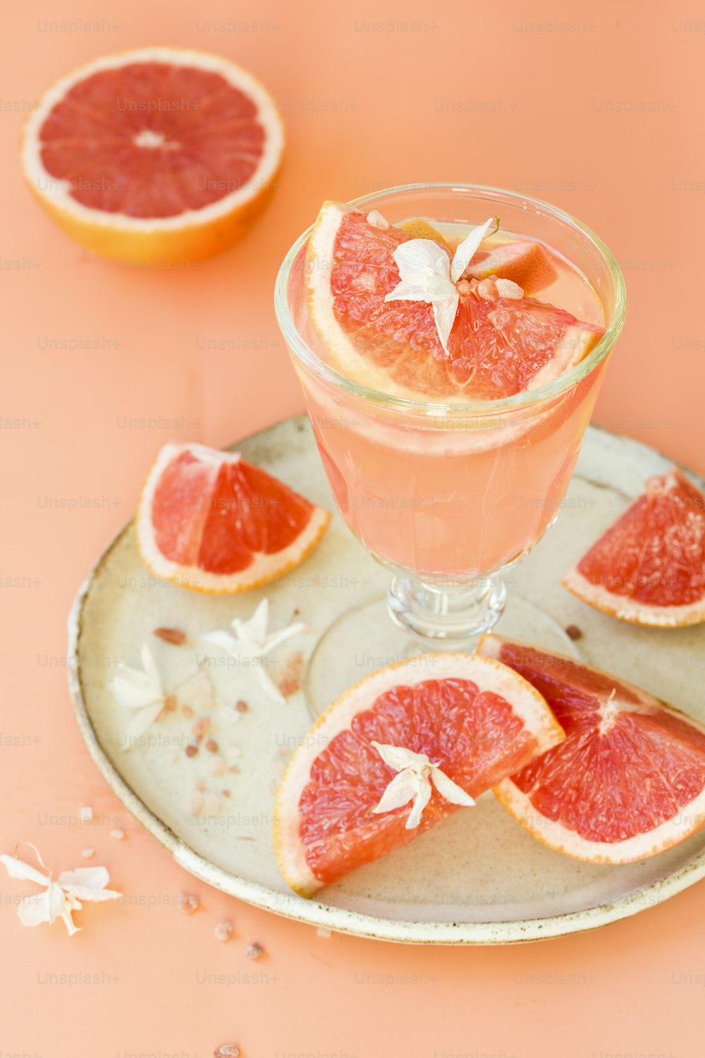 grapefruit cocktail served in a glass with grapefruit garnish