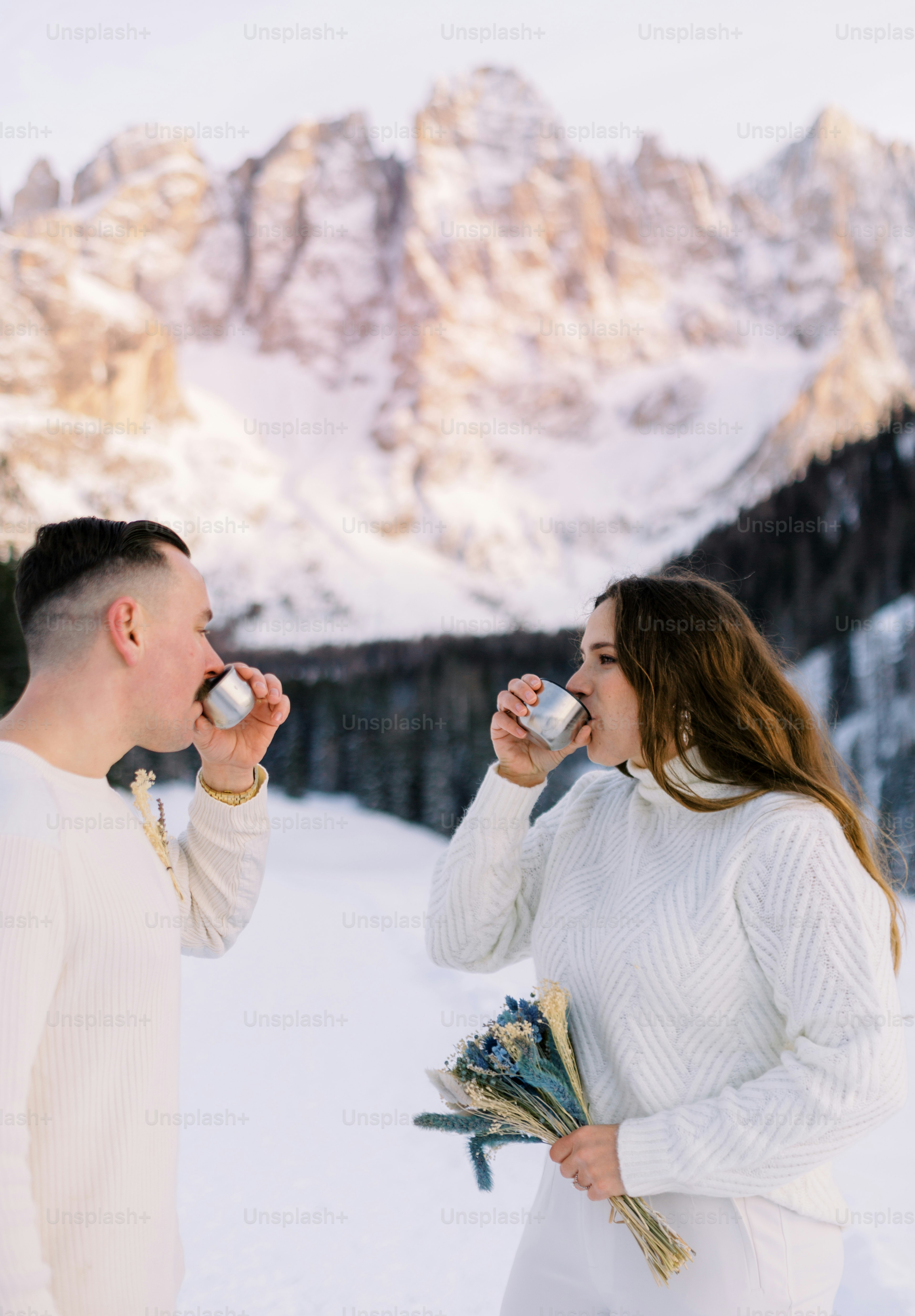 a man and a woman standing in the snow