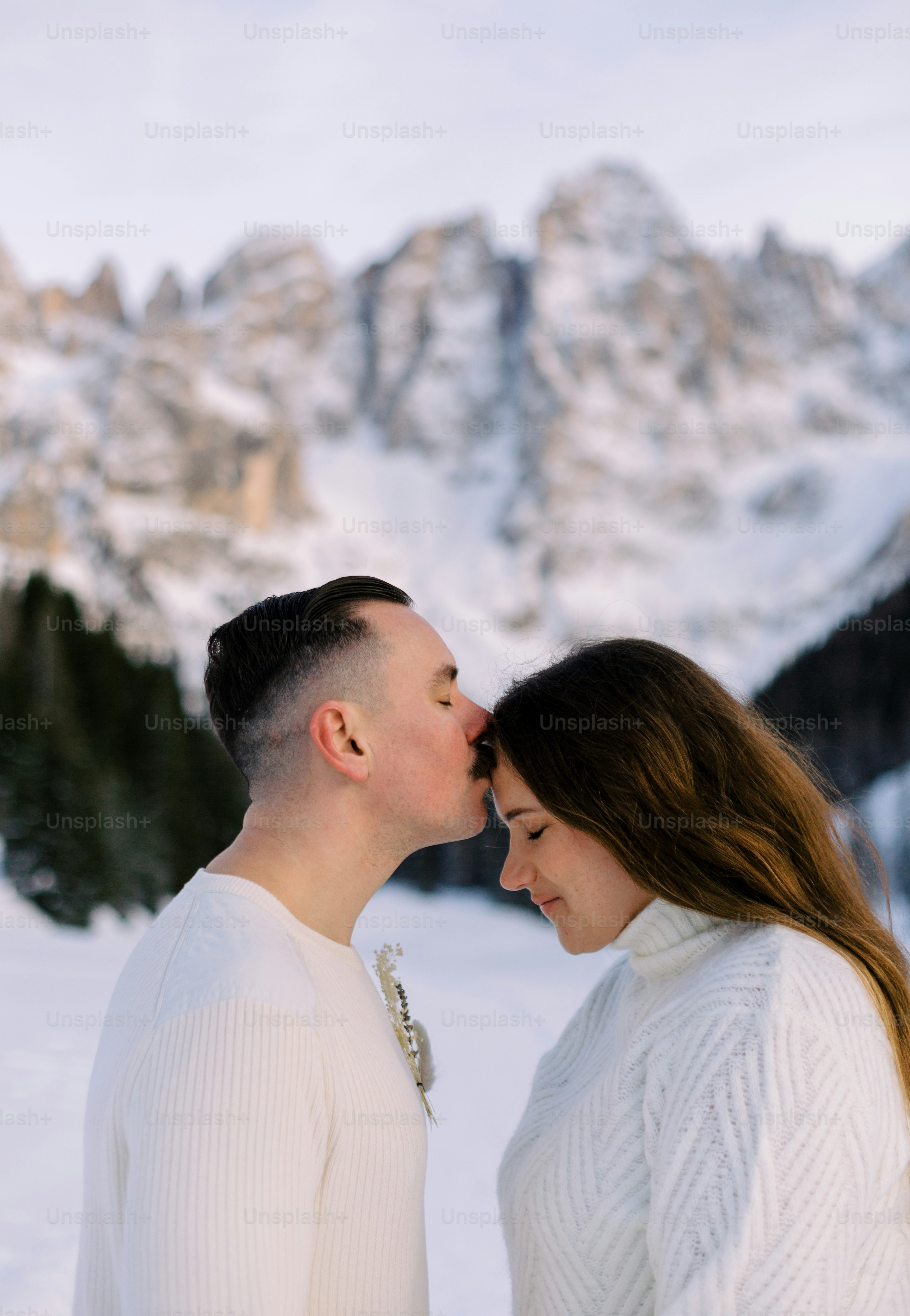 a man and a woman standing in the snow