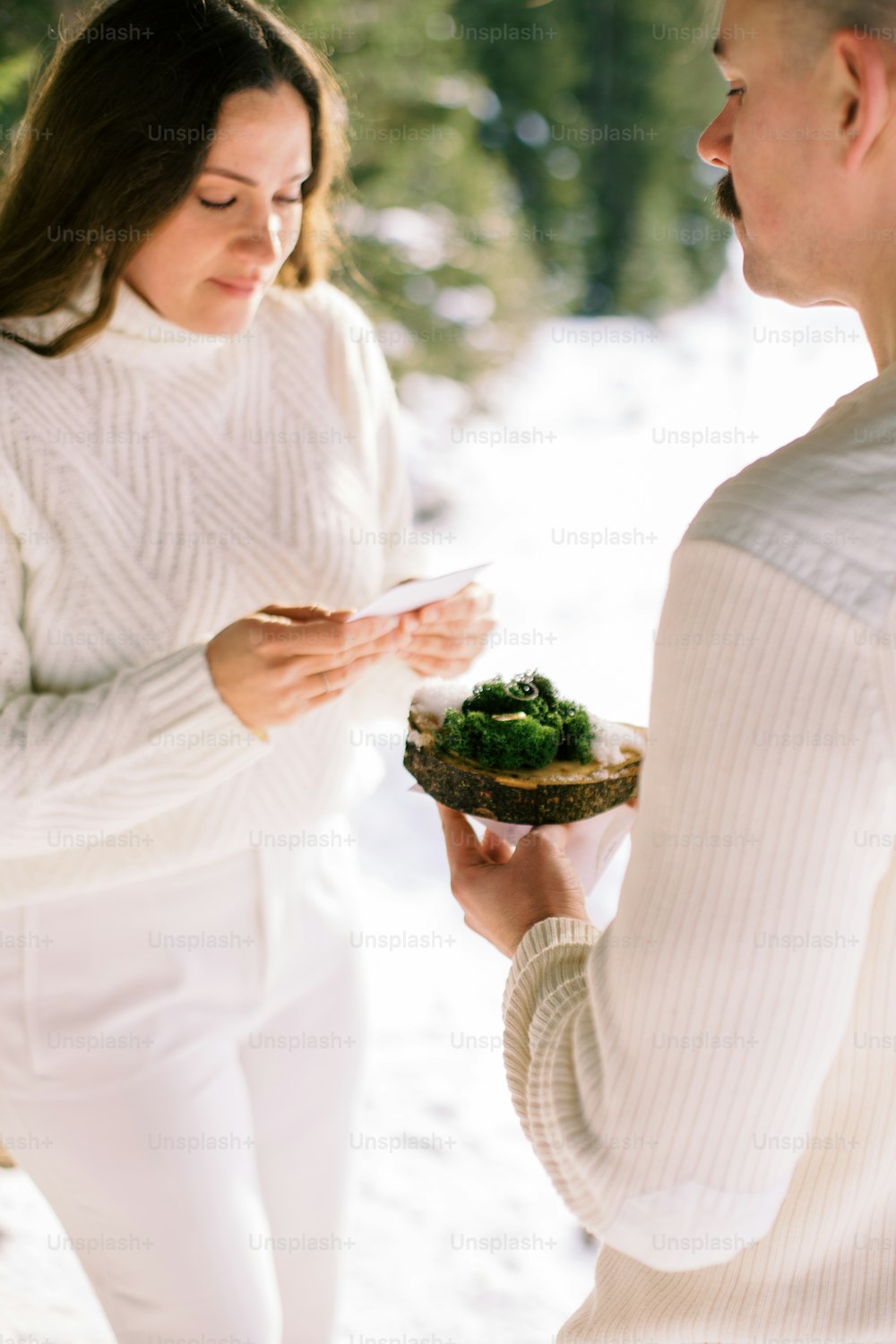 a man holding a plate of food next to a woman