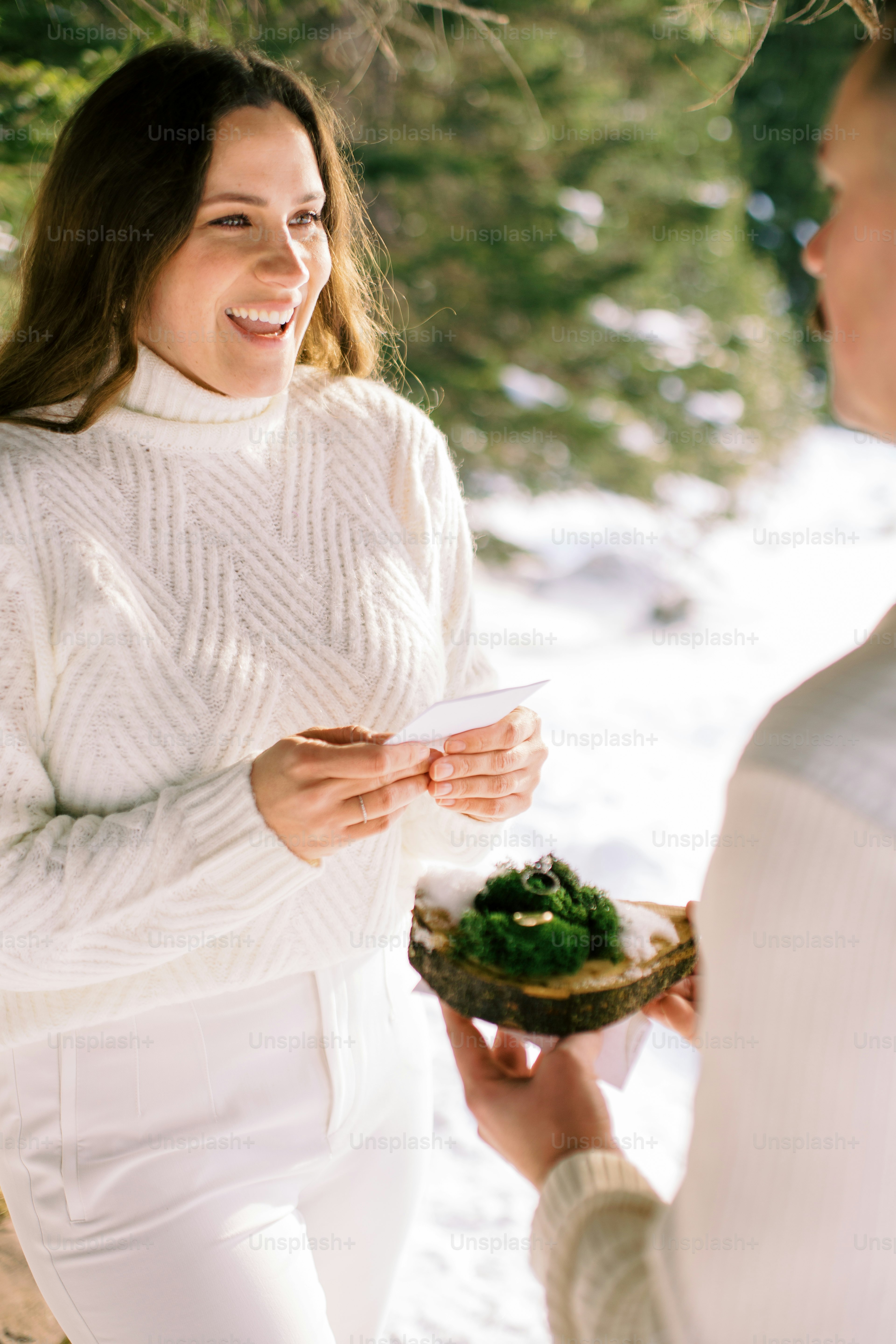 a woman holding a plate of food in the snow