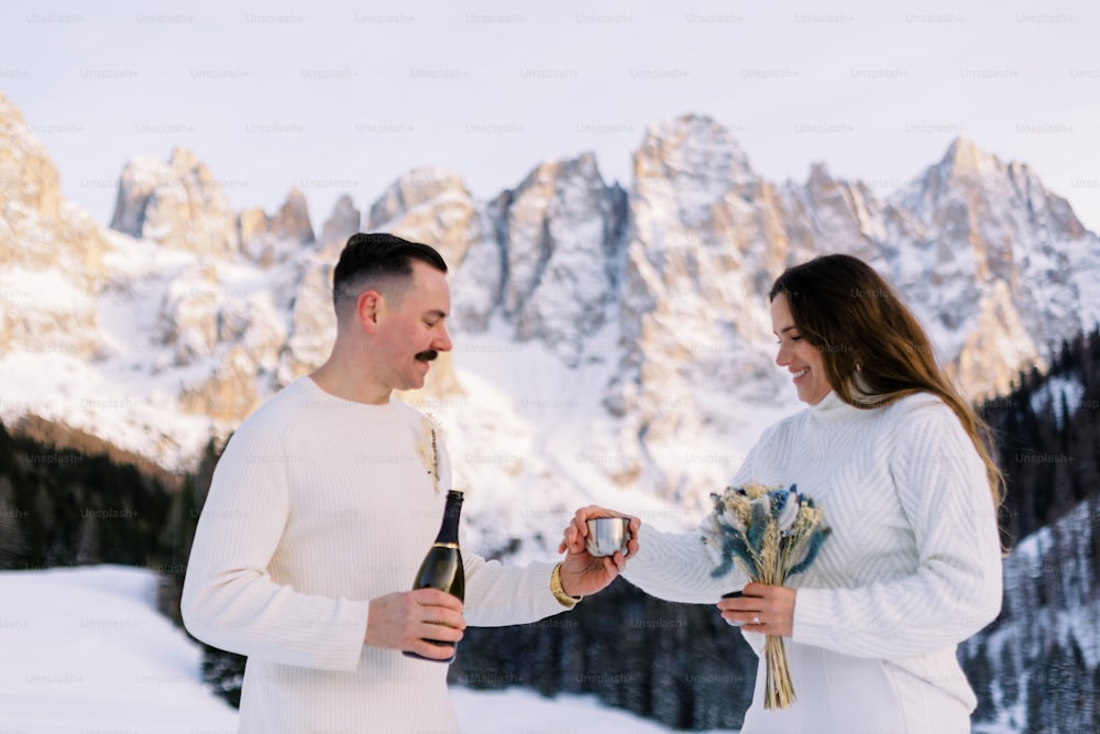 a man and a woman standing in the snow