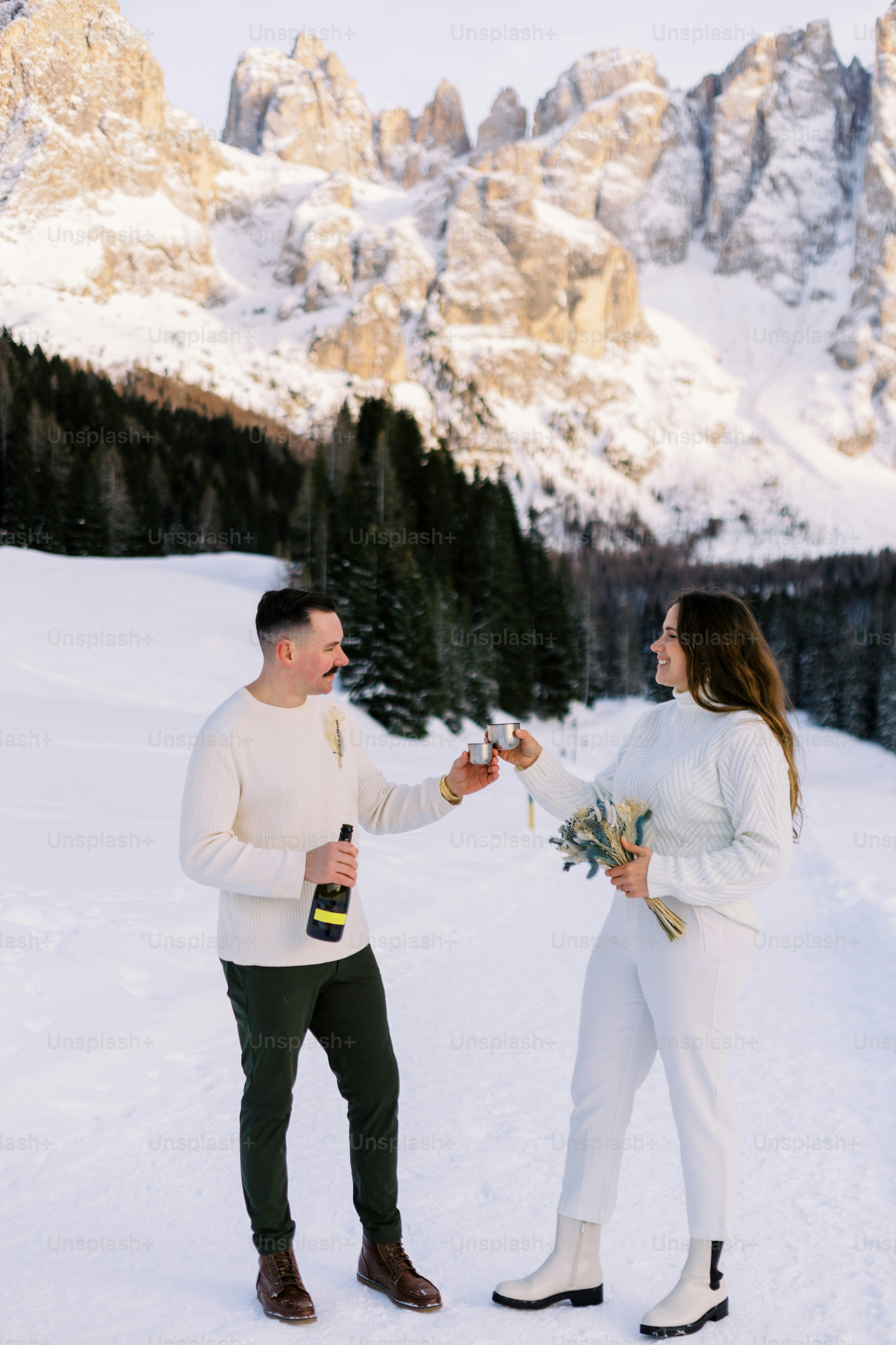 a man and a woman standing in the snow