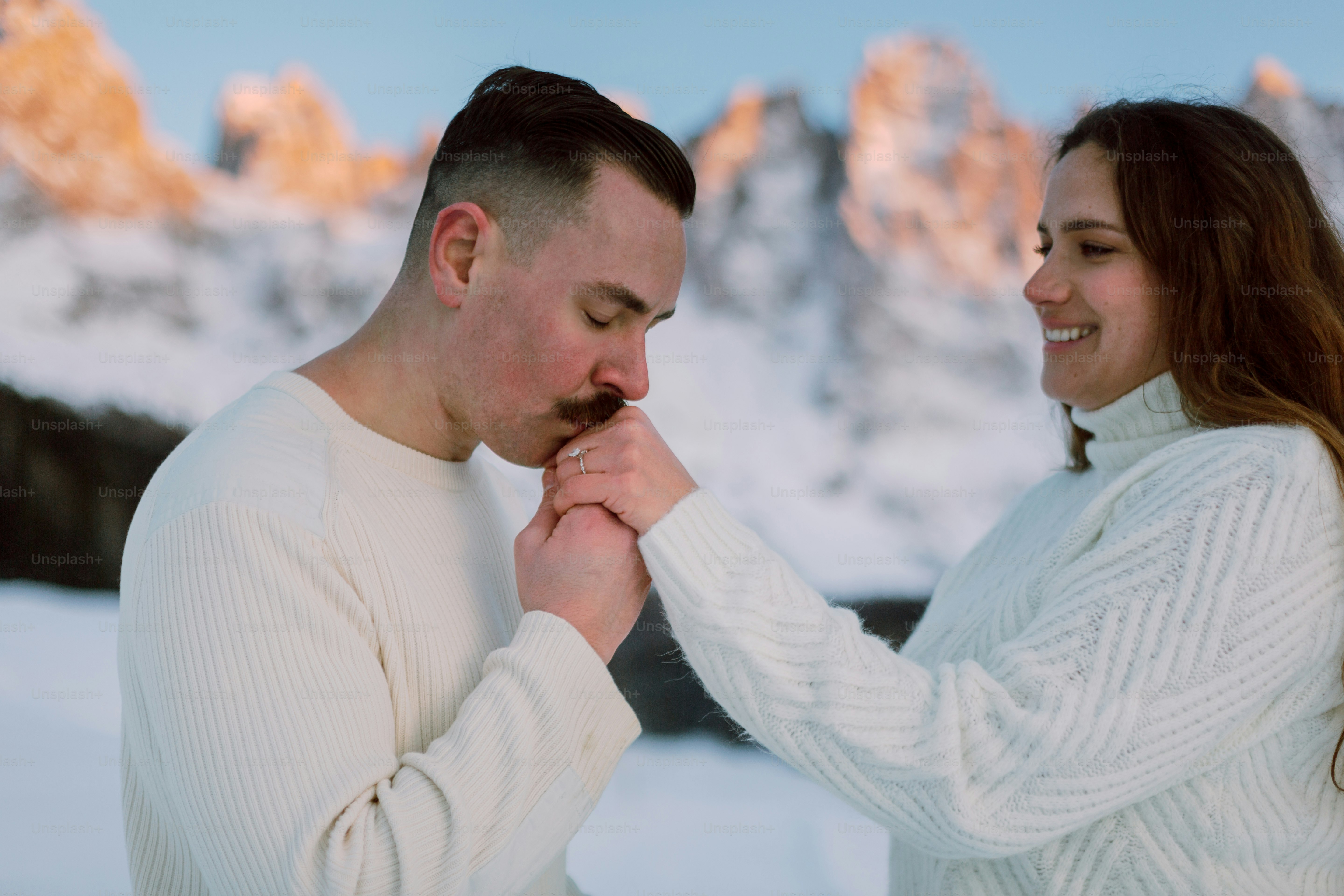 a man and a woman standing in the snow