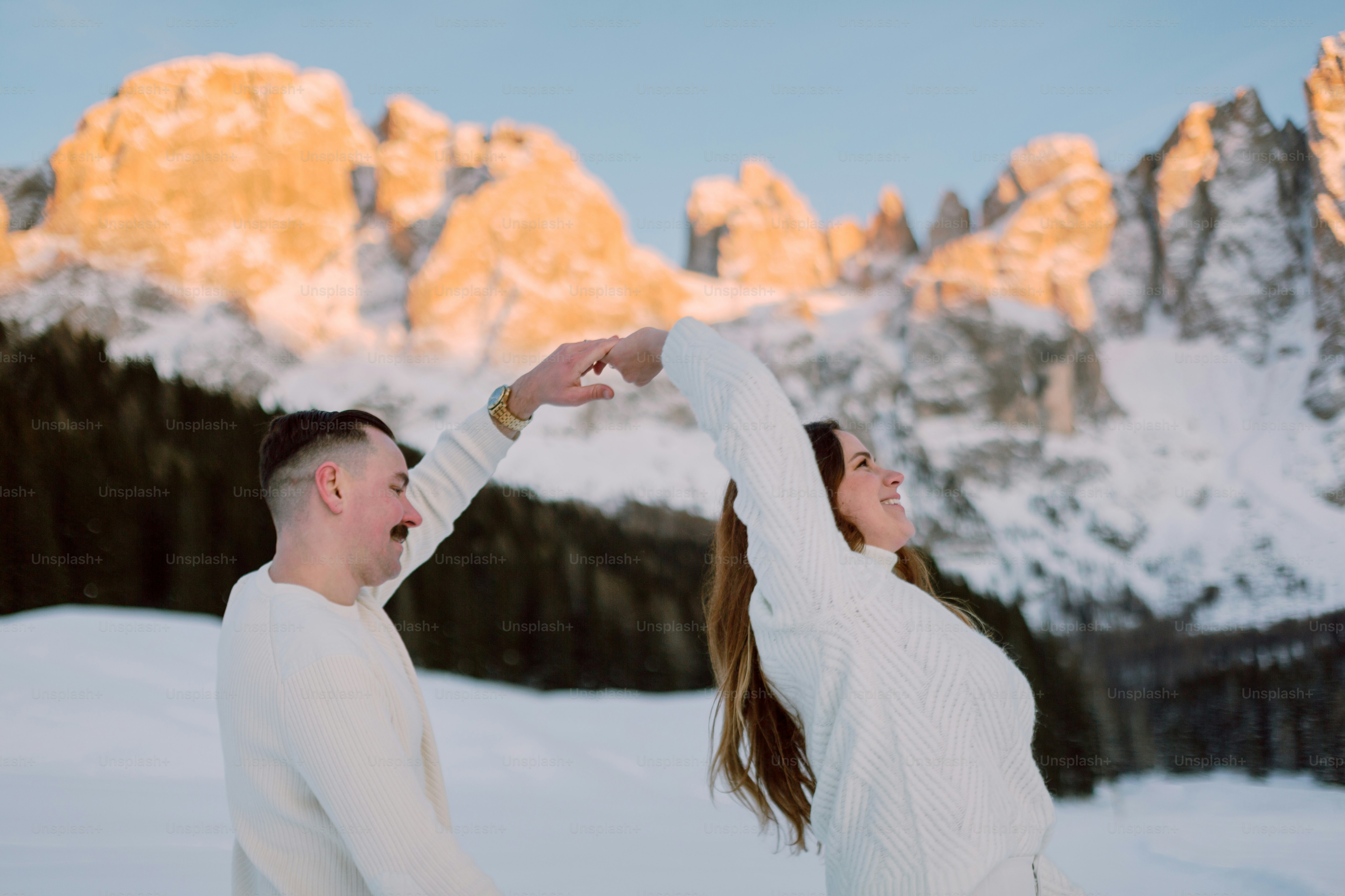 a man and a woman dancing in the snow