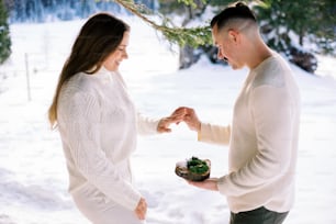 a man and a woman exchanging a piece of cake