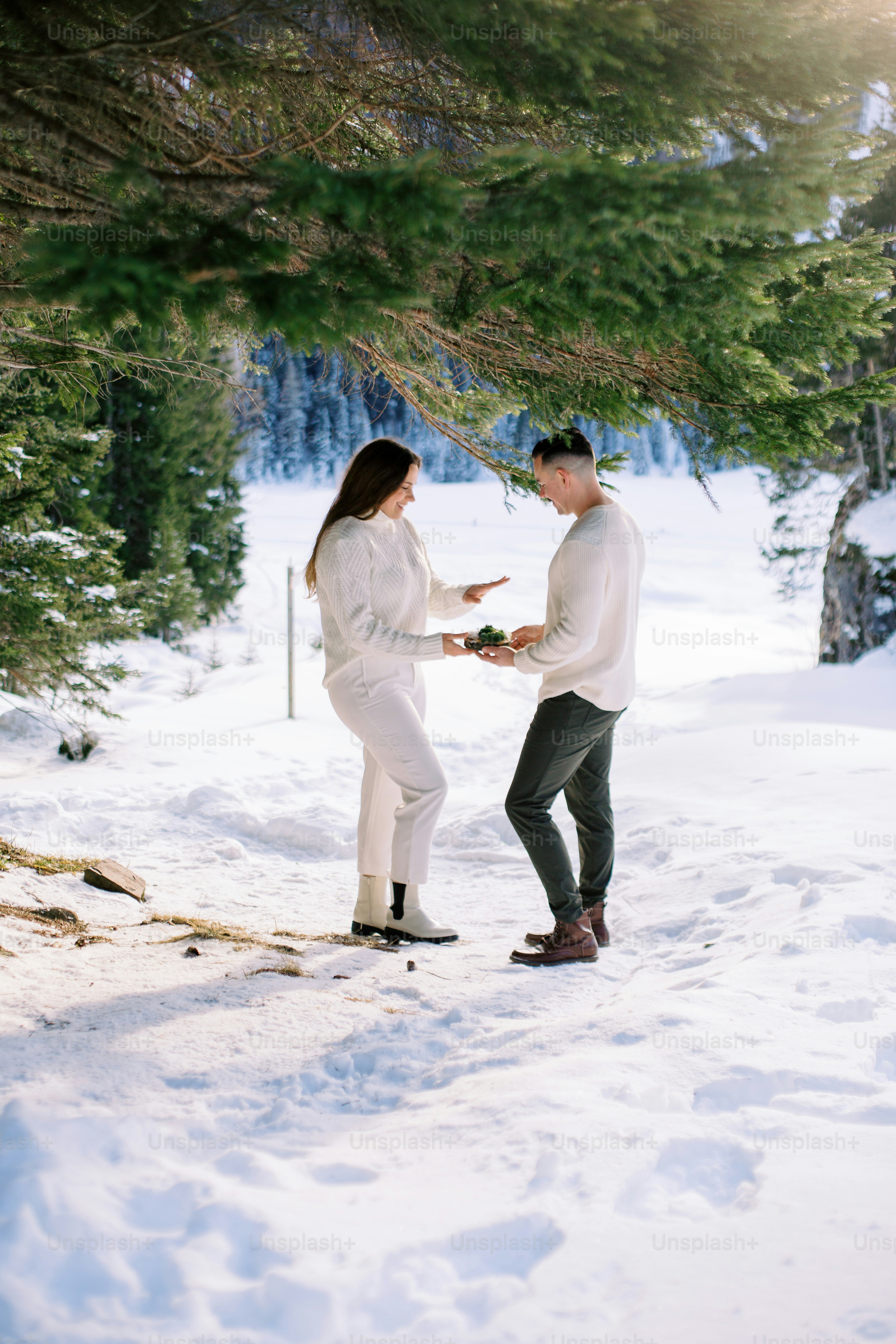 a man and a woman standing in the snow