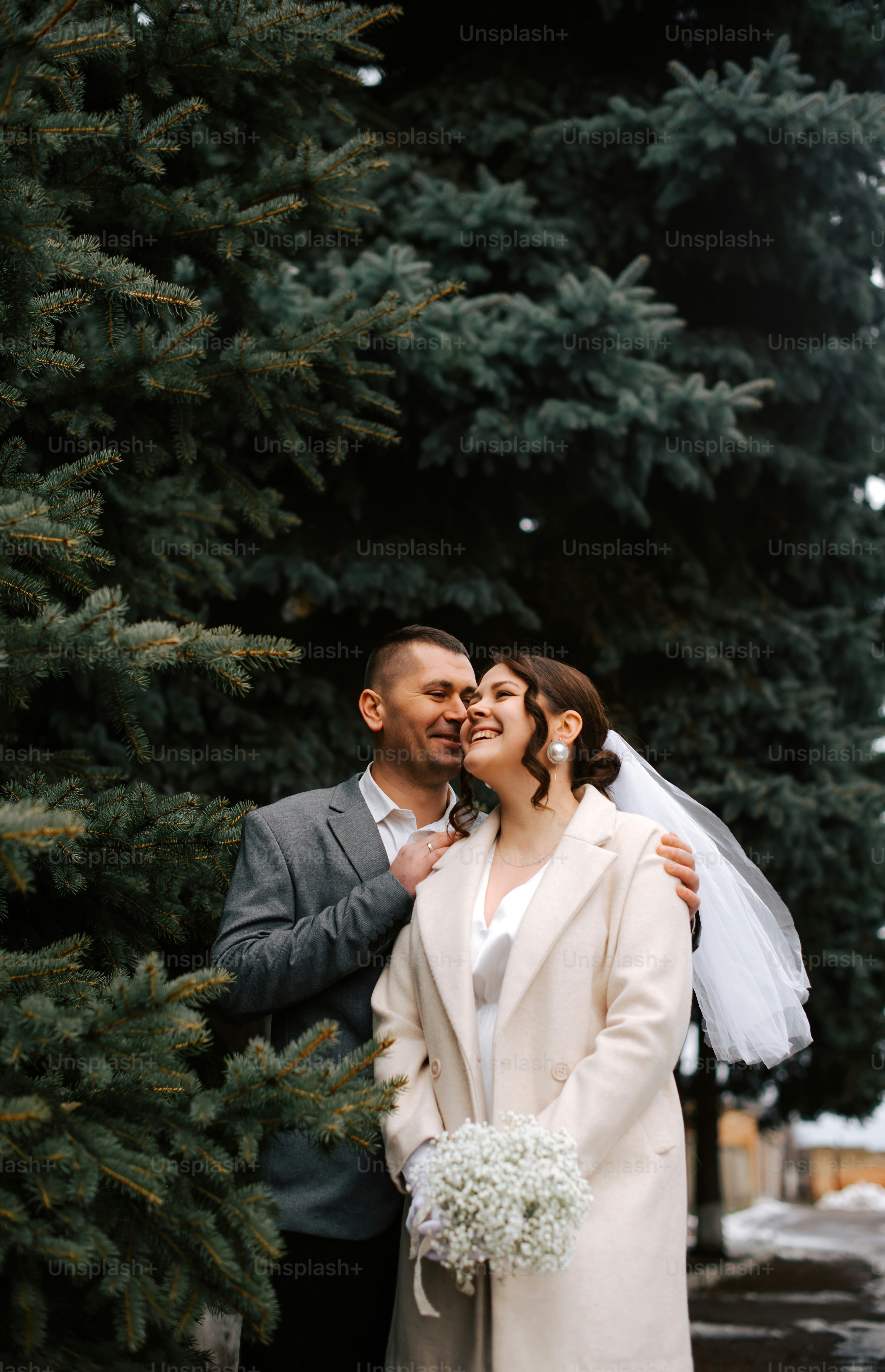A man and woman standing next to each other in front of a building ...