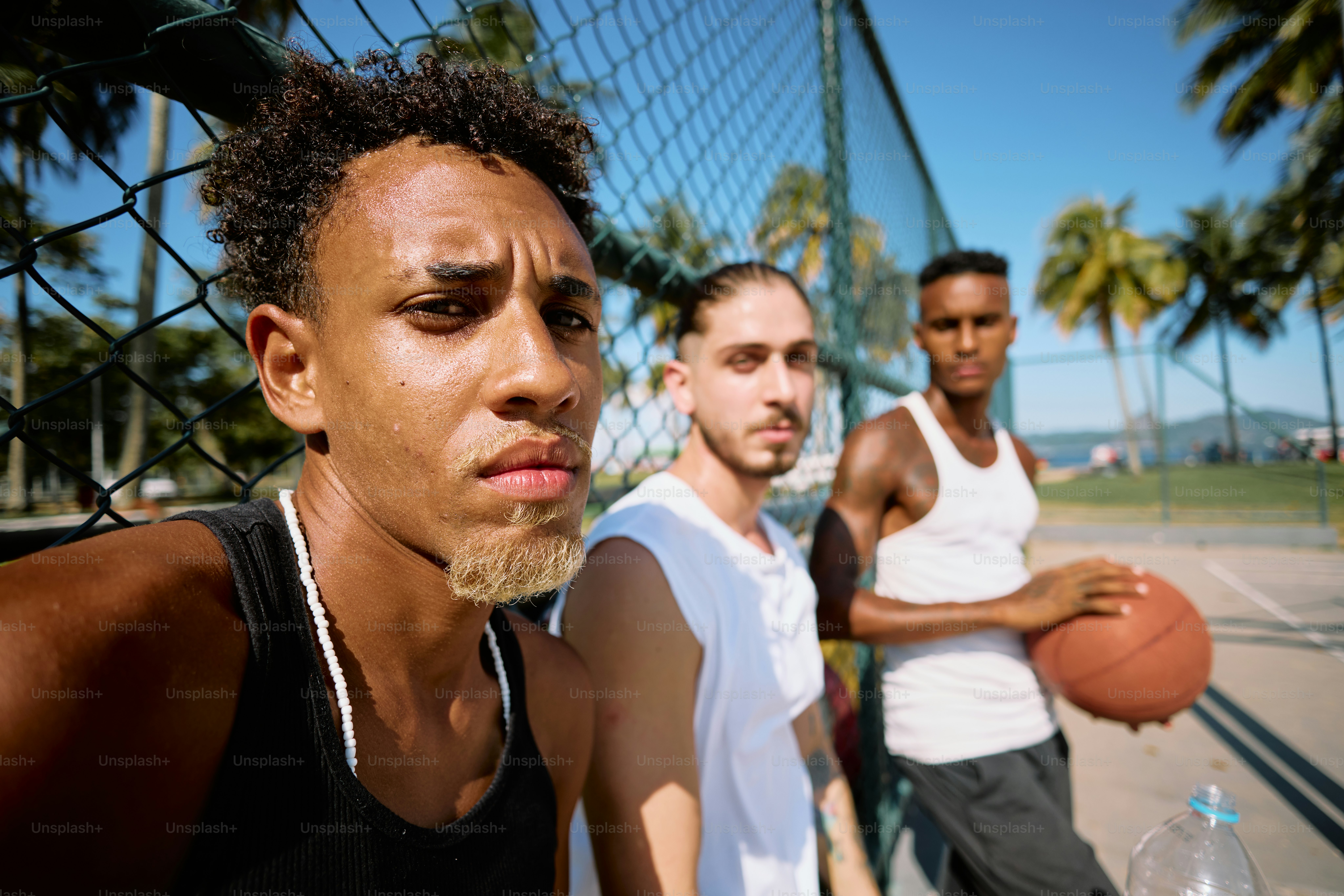 a group of men standing next to each other on a tennis court