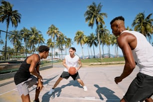 a group of young men playing a game of basketball