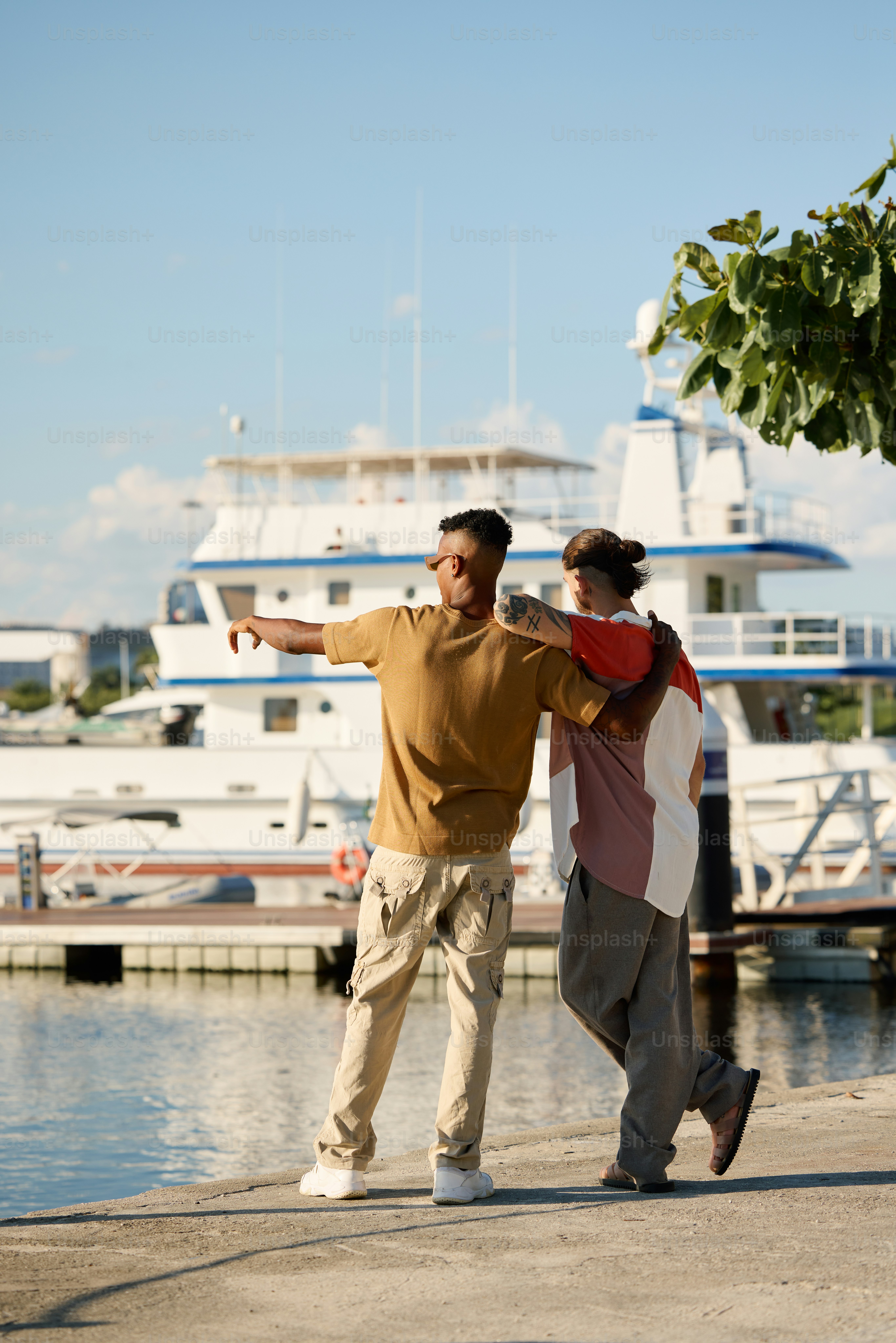 a man and a woman standing next to a body of water