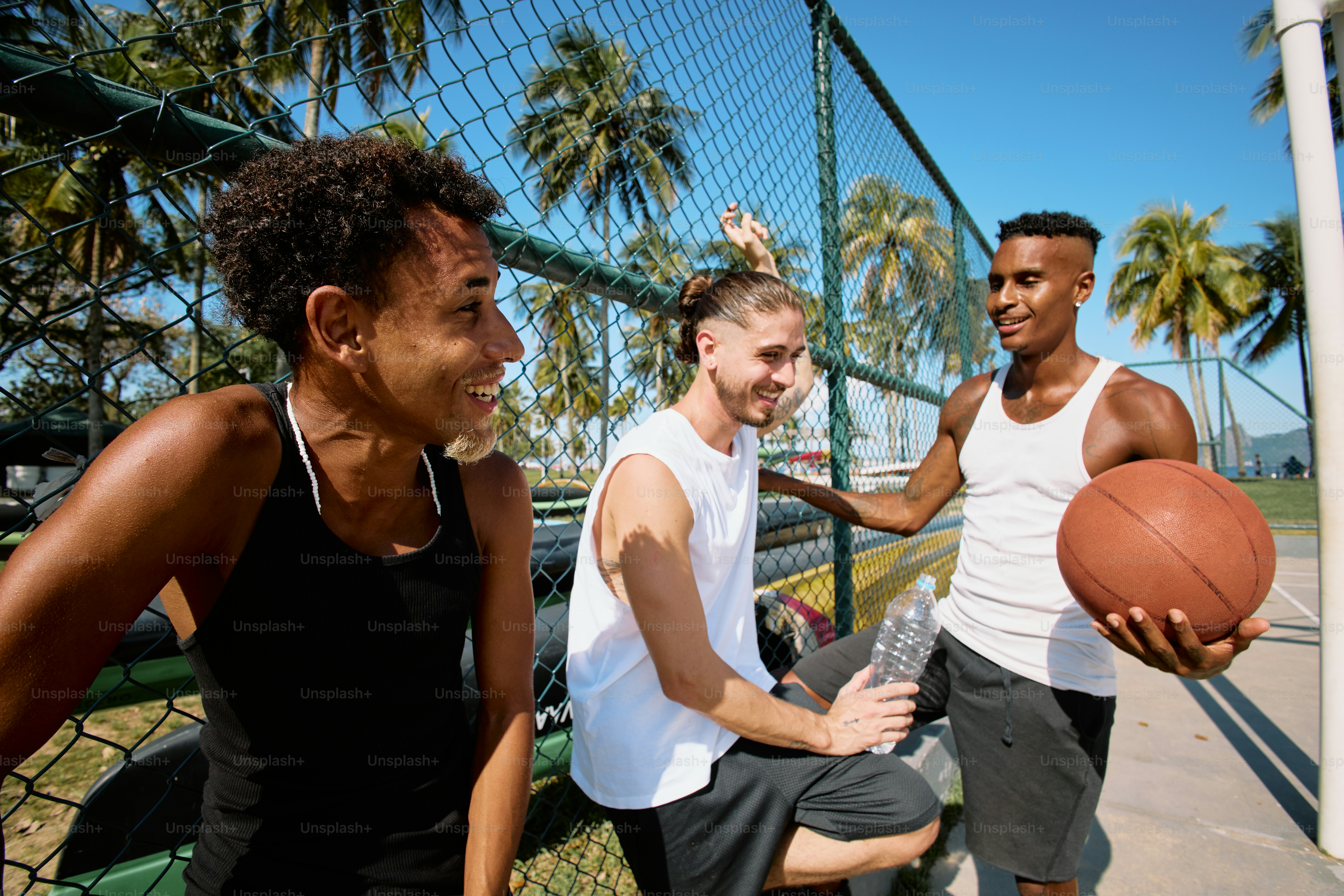 a group of young men playing a game of basketball