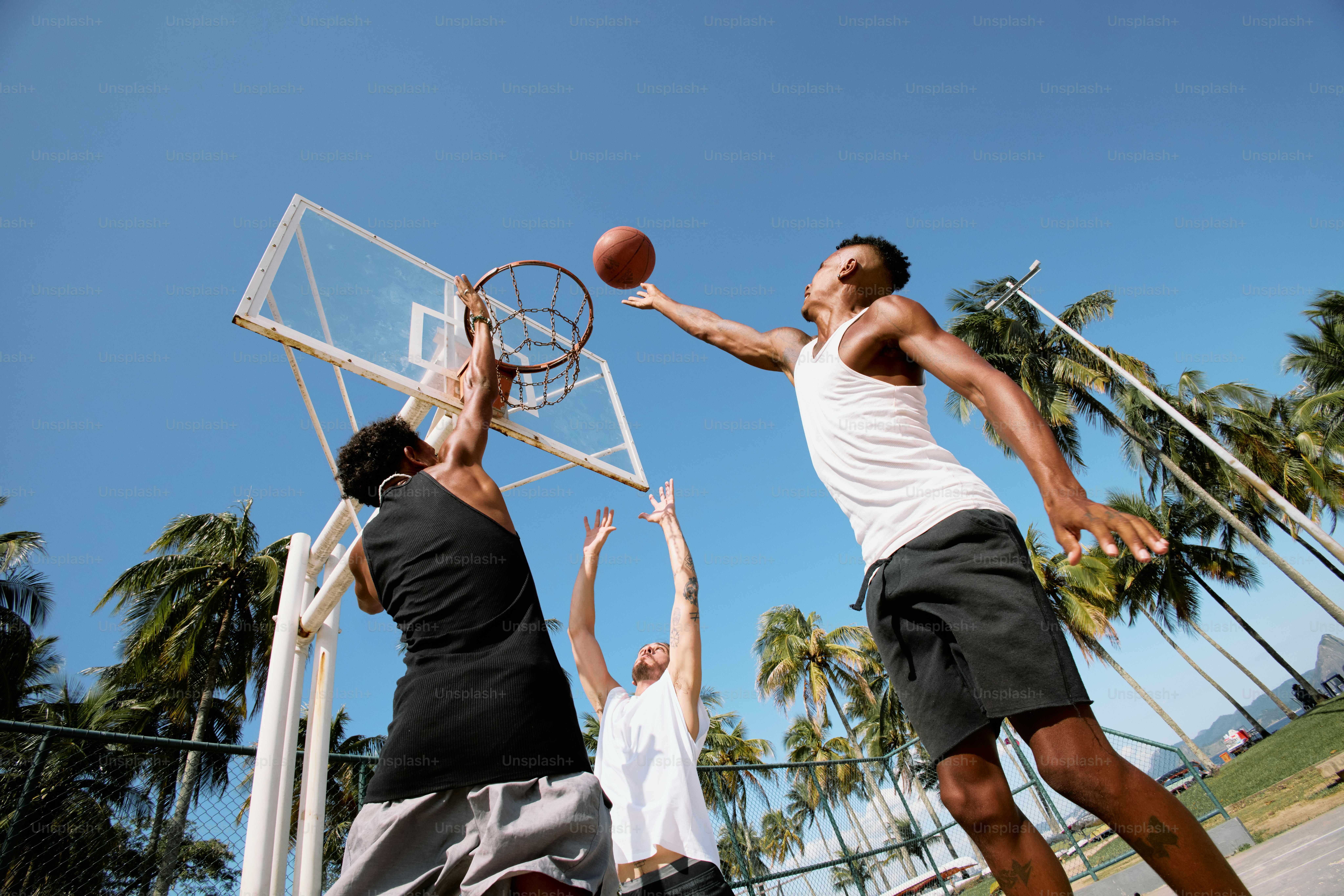 a group of young men playing a game of basketball
