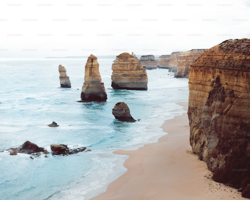 a view of a beach with some rocks in the water