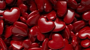 a pile of red heart shaped candies