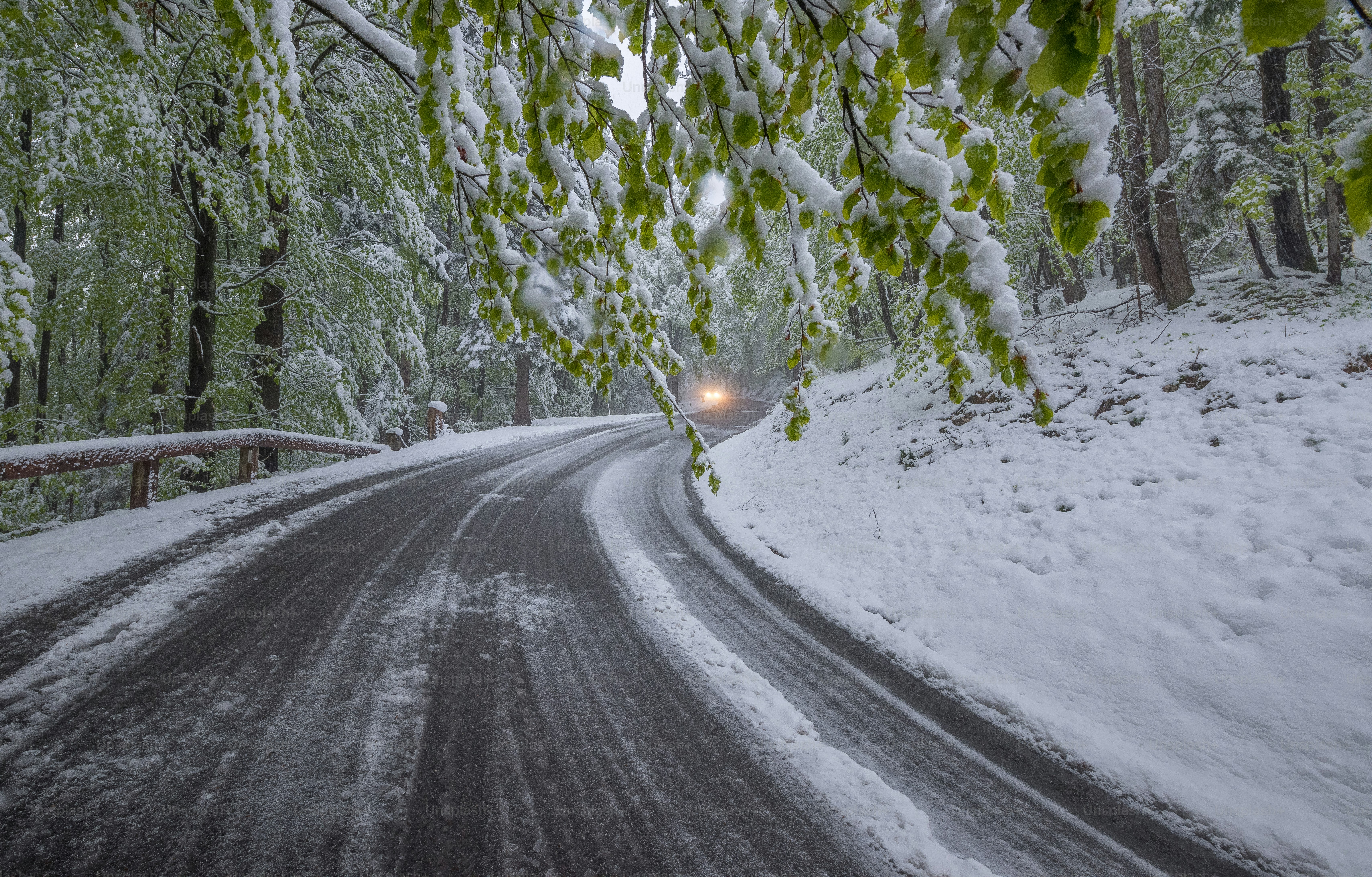 a car driving down a snow covered road