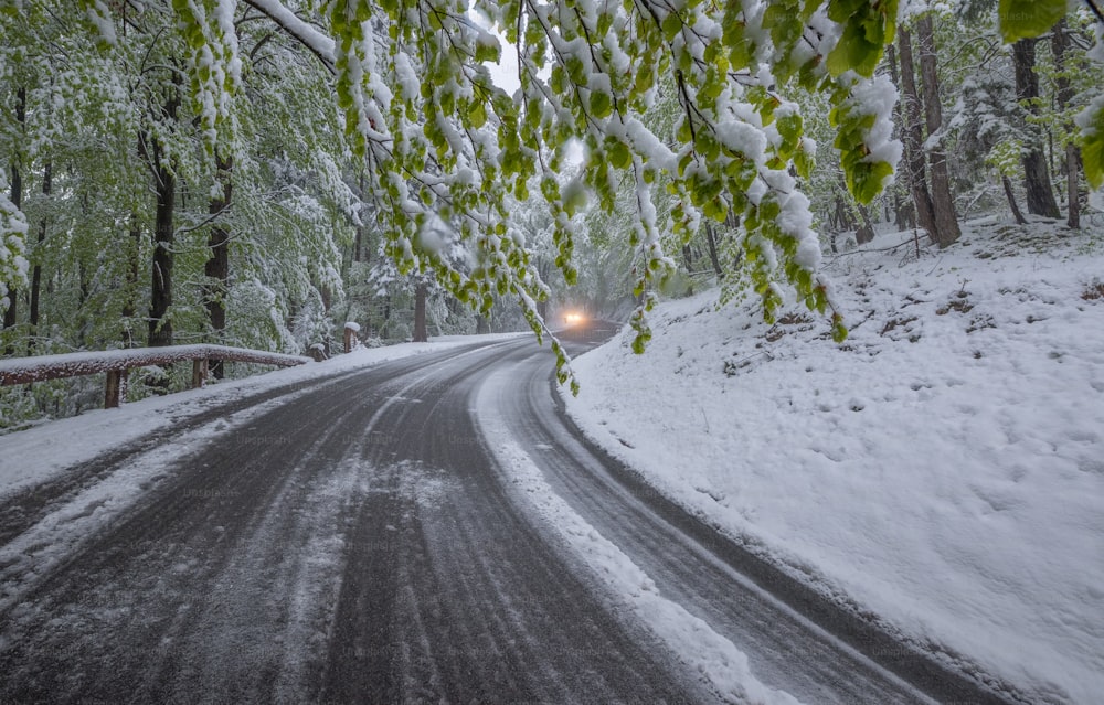 a car driving down a snow covered road