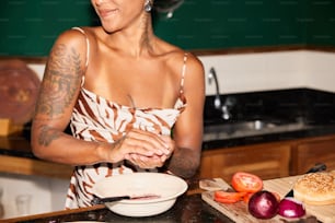 a woman standing in a kitchen preparing food