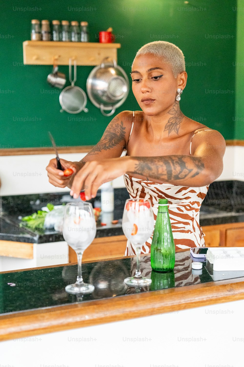 a woman standing at a counter with a knife in her hand