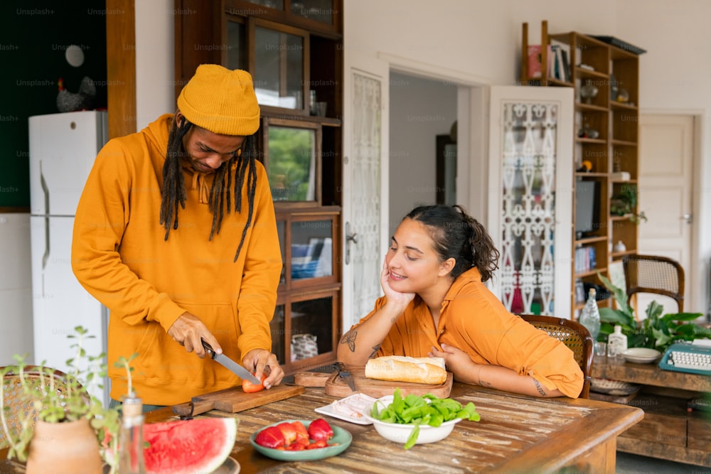 a man and a woman preparing food in a kitchen